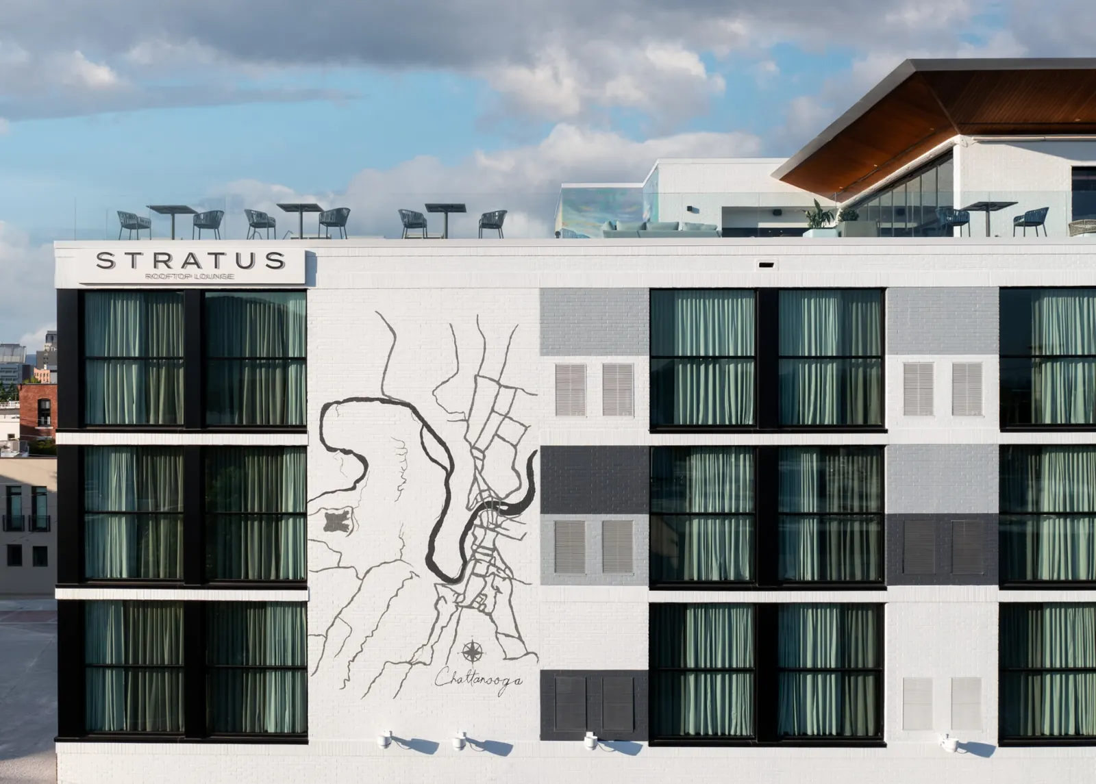 Caption by Hyatt exterior building mural with Chattanooga map