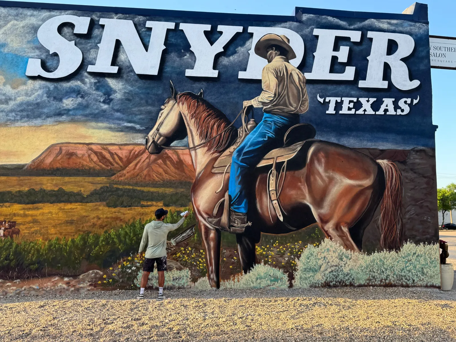 Out West mural of cowboy on horseback in Snyder Texas